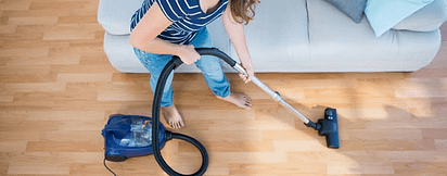 Woman Vacuuming Wood Floor